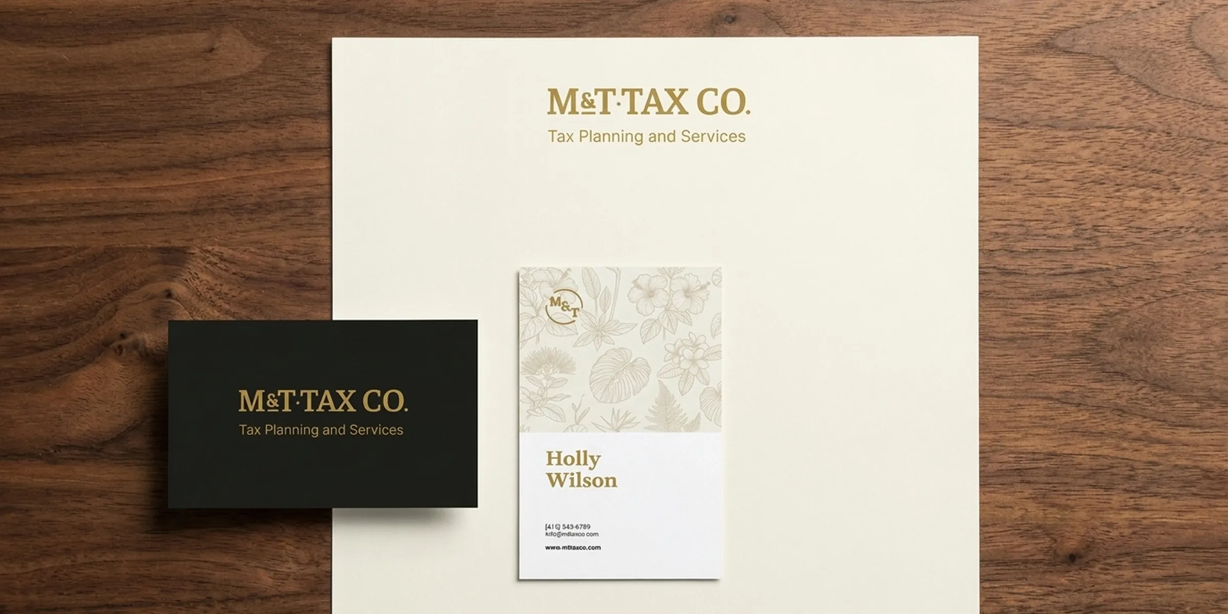 M&T Tax Co. stationery mockup with letterhead, business card, and branded notecard on a wood surface